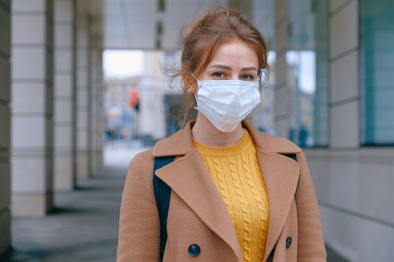 woman wearing facemask because of virus (coronavirus or covid)