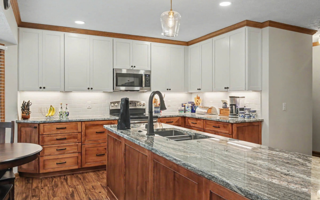 Yorktown kitchen remodel with two-tone cabinetry, stone countertops, backsplash, and large island