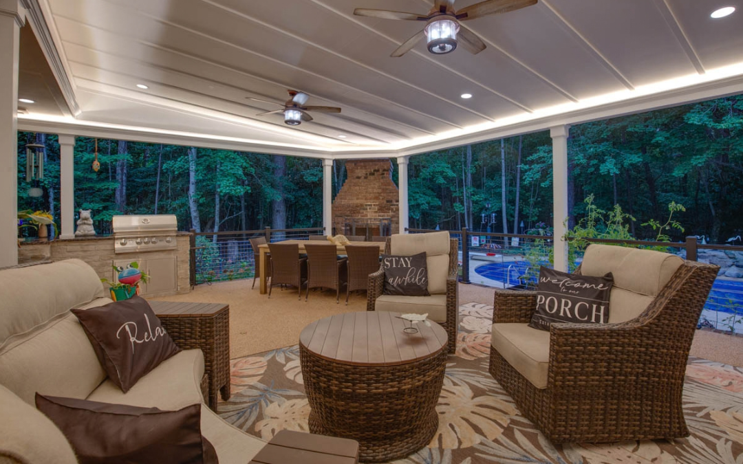 Yorktown covered outdoor living space with built-in grill, brick fireplace, dining and lounge areas